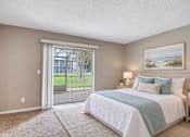 Thumbnail 10 of 24 - Virtually staged bedroom with coastal furnishings at Waterchase Apartments in Largo, FL.
