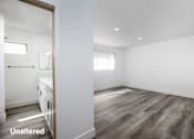 Thumbnail 13 of 63 - A room with a wooden floor and white walls.