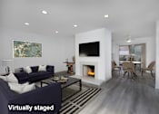 Thumbnail 10 of 63 - A modern living room with a fireplace and a painting on the wall.
