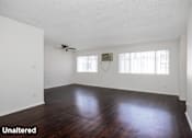 Thumbnail 6 of 18 - A room with wooden floors and white walls.