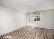 Thumbnail 3 of 45 - A room with unaltered wooden flooring and a window.