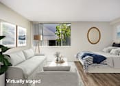 Thumbnail 14 of 57 - A living room with a grey couch and a white bed.