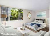 Thumbnail 20 of 57 - A modern bedroom with a large bed and a view of the outdoors.
