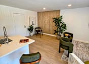 Thumbnail 9 of 57 - A room with a white counter and green chairs.