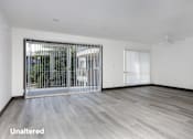 Thumbnail 2 of 52 - A room with a sliding door and unaltered flooring.
