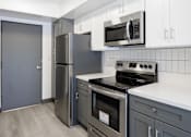 Thumbnail 52 of 52 - a kitchen with stainless steel appliances and white cabinets
