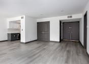 Thumbnail 49 of 52 - the living room and kitchen of an empty apartment with black doors and white walls