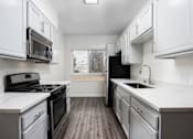 Thumbnail 28 of 34 - a kitchen with white cabinets and white countertops