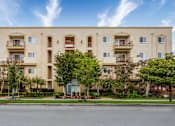 Thumbnail 1 of 34 - a large apartment building with trees in front of it
