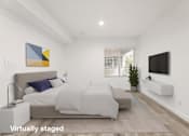 Thumbnail 8 of 33 - A bedroom with a bed, a couch, a television, and a painting on the wall.