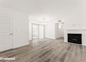 Thumbnail 5 of 33 - A room with a fireplace and wood flooring.