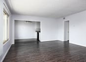 Thumbnail 33 of 41 - an empty living room with white walls and wood floors