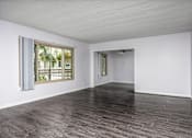 Thumbnail 34 of 41 - an empty living room with white walls and a window