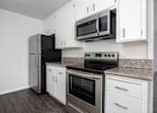 Thumbnail 38 of 41 - a kitchen with stainless steel appliances and white cabinets