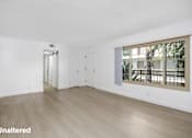 Thumbnail 10 of 41 - A room with unaltered flooring and a window showing a tree.
