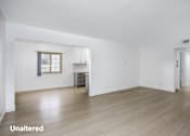 Thumbnail 16 of 41 - A room with wooden floors and white walls.