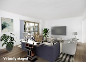 Thumbnail 9 of 41 - A modern living room with a purple couch and a television on the wall.