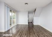 Thumbnail 12 of 23 - A room with unaltered wooden flooring and white walls.