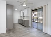 Thumbnail 19 of 63 - an empty kitchen with a sliding glass door to a patio