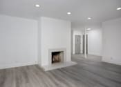 Thumbnail 21 of 63 - a living room with a fireplace and white walls
