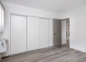 Thumbnail 23 of 63 - an empty room with white walls and white closet doors