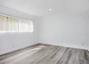 Thumbnail 26 of 63 - an empty room with white walls and wooden floors