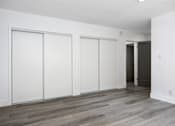 Thumbnail 28 of 63 - an empty room with white walls and wood floors