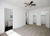 Thumbnail 14 of 18 - a living room with a rug and a ceiling fan