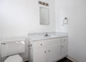 Thumbnail 15 of 18 - an empty bathroom with a sink and a toilet