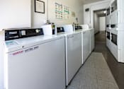 Thumbnail 18 of 18 - a row of washing machines in a room with a long line ofidges