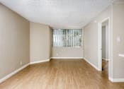 Thumbnail 29 of 45 - A room with wooden flooring and a window with blinds.