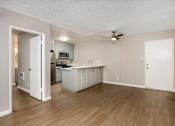 Thumbnail 27 of 45 - A kitchen with white cabinets and a wooden floor.
