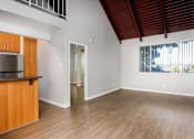Thumbnail 28 of 45 - A room with wooden floors and a window with blinds.