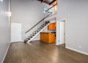 Thumbnail 36 of 45 - A room with a staircase and a white door.
