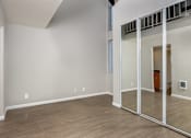 Thumbnail 32 of 45 - A room with a white wall and wooden floor.
