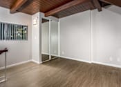 Thumbnail 41 of 45 - A room with a wooden ceiling and a glass door.