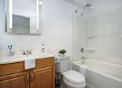 Thumbnail 23 of 45 - a bathroom with a sink toilet and a bath tub