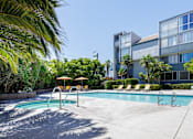 Thumbnail 8 of 45 - a swimming pool with a building in the background