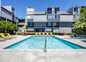 Thumbnail 9 of 45 - a swimming pool in front of an apartment building