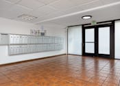 Thumbnail 3 of 19 - a large room with lockers on the wall and a door