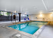 Thumbnail 6 of 19 - a swimming pool with chairs and a fence around it