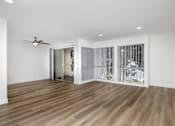 Thumbnail 30 of 52 - a living room with white walls and wood floors and a sliding glass door