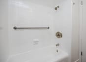 Thumbnail 43 of 52 - a bathroom with a shower and a tub and a towel rack