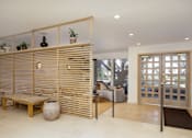 Thumbnail 29 of 52 - a living room with a wooden wall and a door