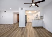 Thumbnail 36 of 52 - a living room with white walls and a ceiling fan