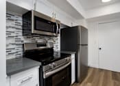 Thumbnail 38 of 52 - a kitchen with stainless steel appliances and a refrigerator