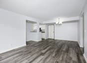 Thumbnail 30 of 53 - A room with a wooden floor and white walls.