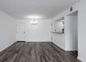 Thumbnail 17 of 53 - A room with wooden flooring and white walls.