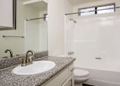 Thumbnail 46 of 53 - A bathroom with a sink, toilet, and shower.