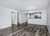 Thumbnail 49 of 53 - A room with a wooden floor and white walls.